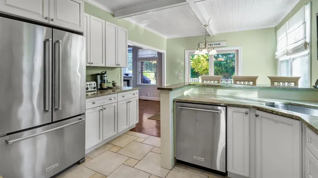 a kitchen with stainless steel appliances granite countertop a refrigerator sink and stove