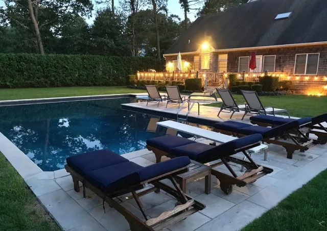 a view of a backyard with sitting area