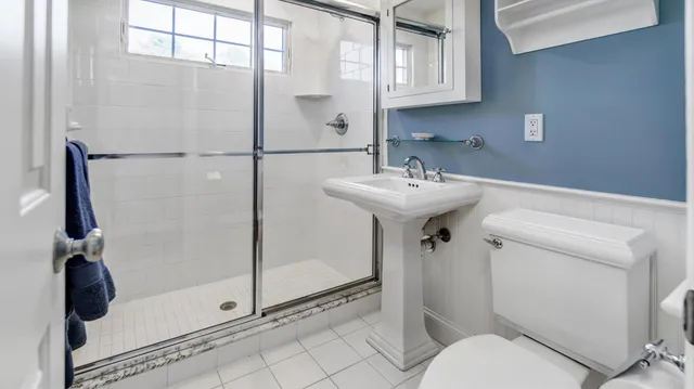 a bathroom with a sink toilet and shower