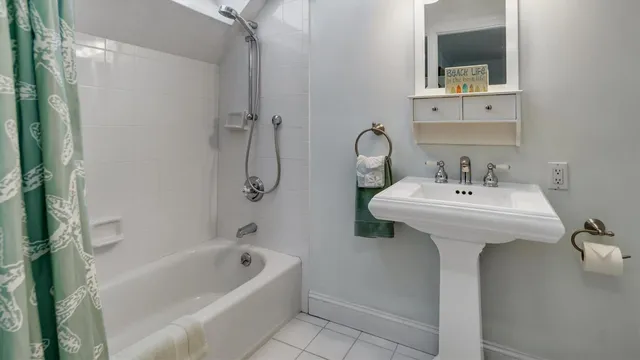 a bathroom with a sink a mirror and a bathtub