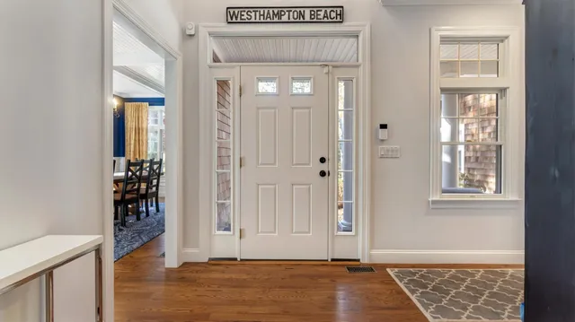 an empty room with wooden floor and a window