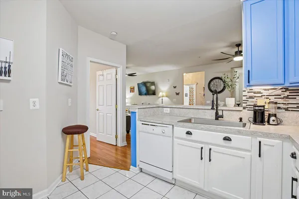 a kitchen with stainless steel appliances a sink cabinets and a refrigerator