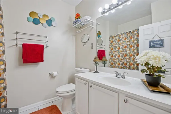 a bathroom with a sink a toilet and a shower