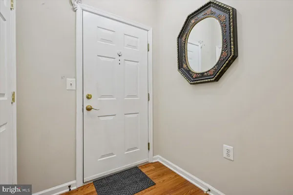 a view of a livingroom with wooden floor and white walls
