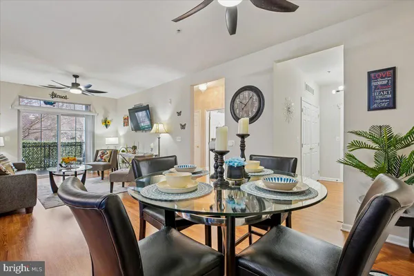 a view of a dining room with furniture and a large window