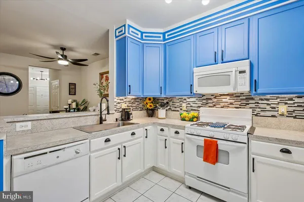 a kitchen with stainless steel appliances granite countertop a sink a stove and cabinets