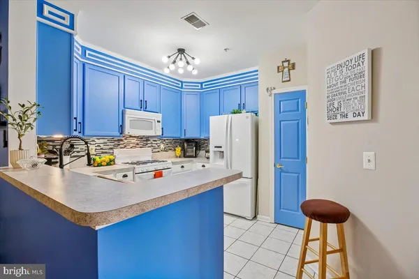 a kitchen with a refrigerator and a sink