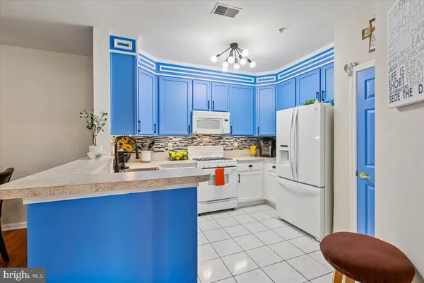 a kitchen with stainless steel appliances a refrigerator and a stove