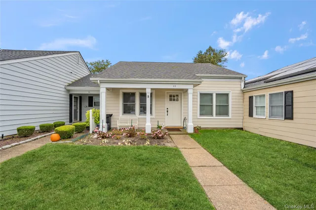 a front view of house with yard and green space