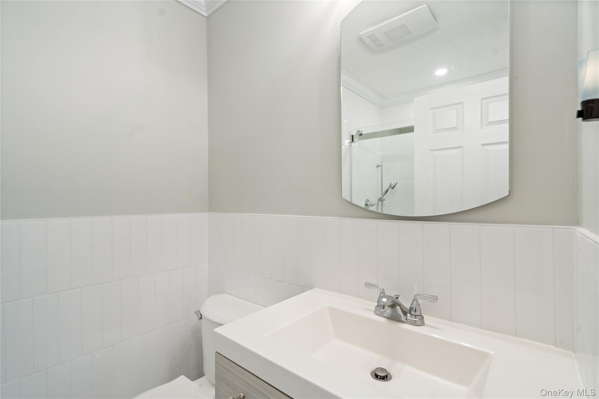 53 Freedom Lane Coram, NY 11784 - Photo 14 of 29 a bathroom with a sink and mirror