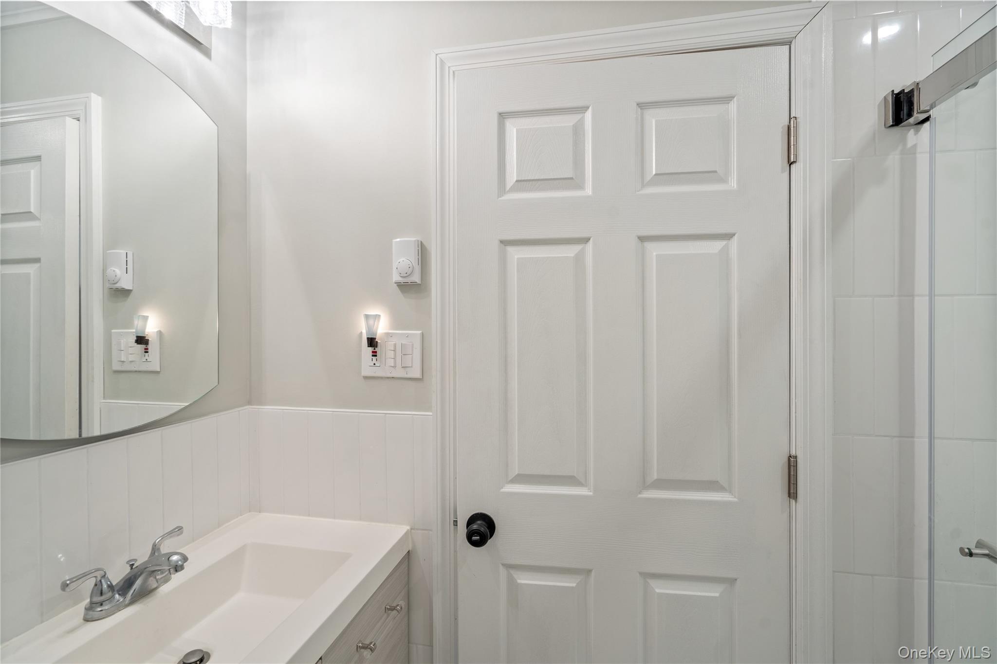 53 Freedom Lane Coram, NY 11784 - Photo 16 of 29 a bathroom with a sink and a mirror