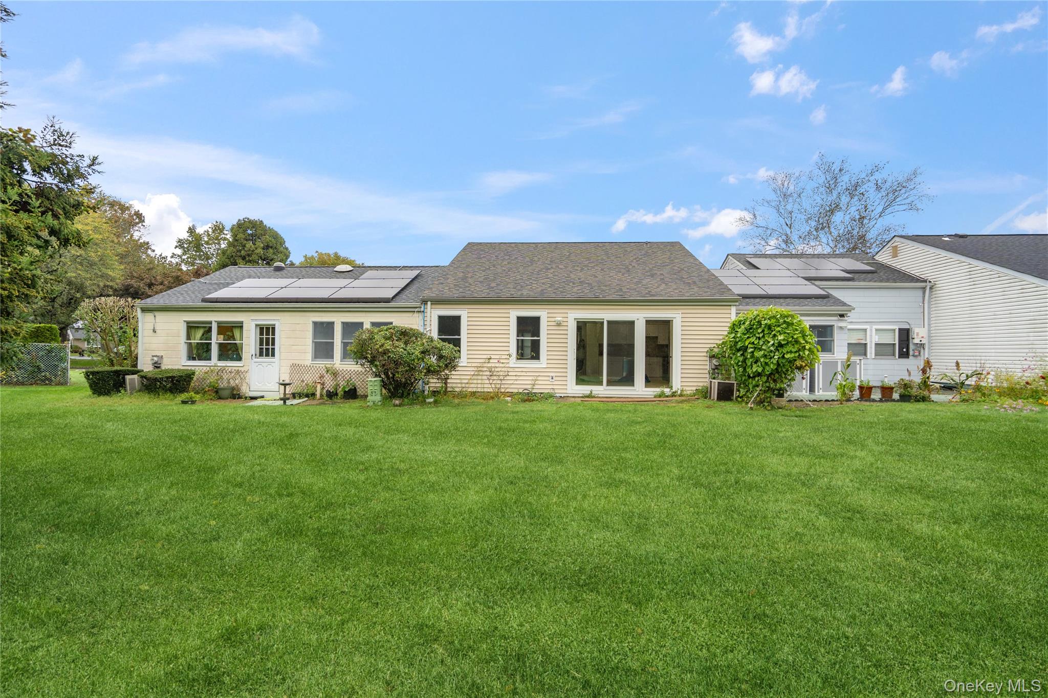 53 Freedom Lane Coram, NY 11784 - Photo 20 of 29 a front view of a house with a garden