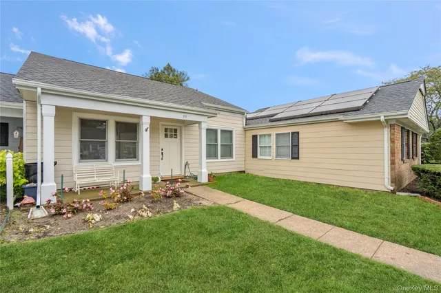 a front view of a house with a garden