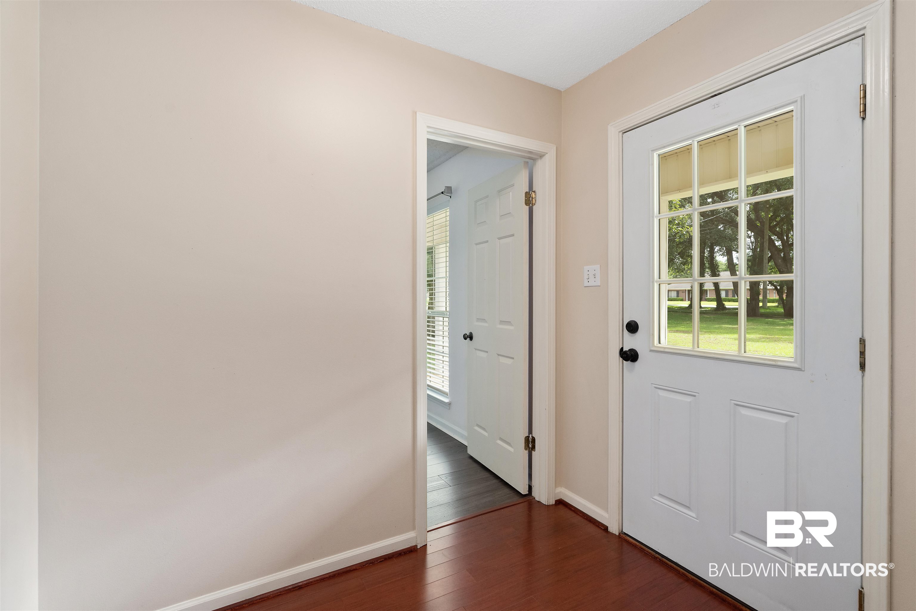 25779 Austin Road Daphne, AL 36526 - Photo 26 of 30 Doorway to outside with healthy amount of natural light, dark wood-type flooring, and baseboards