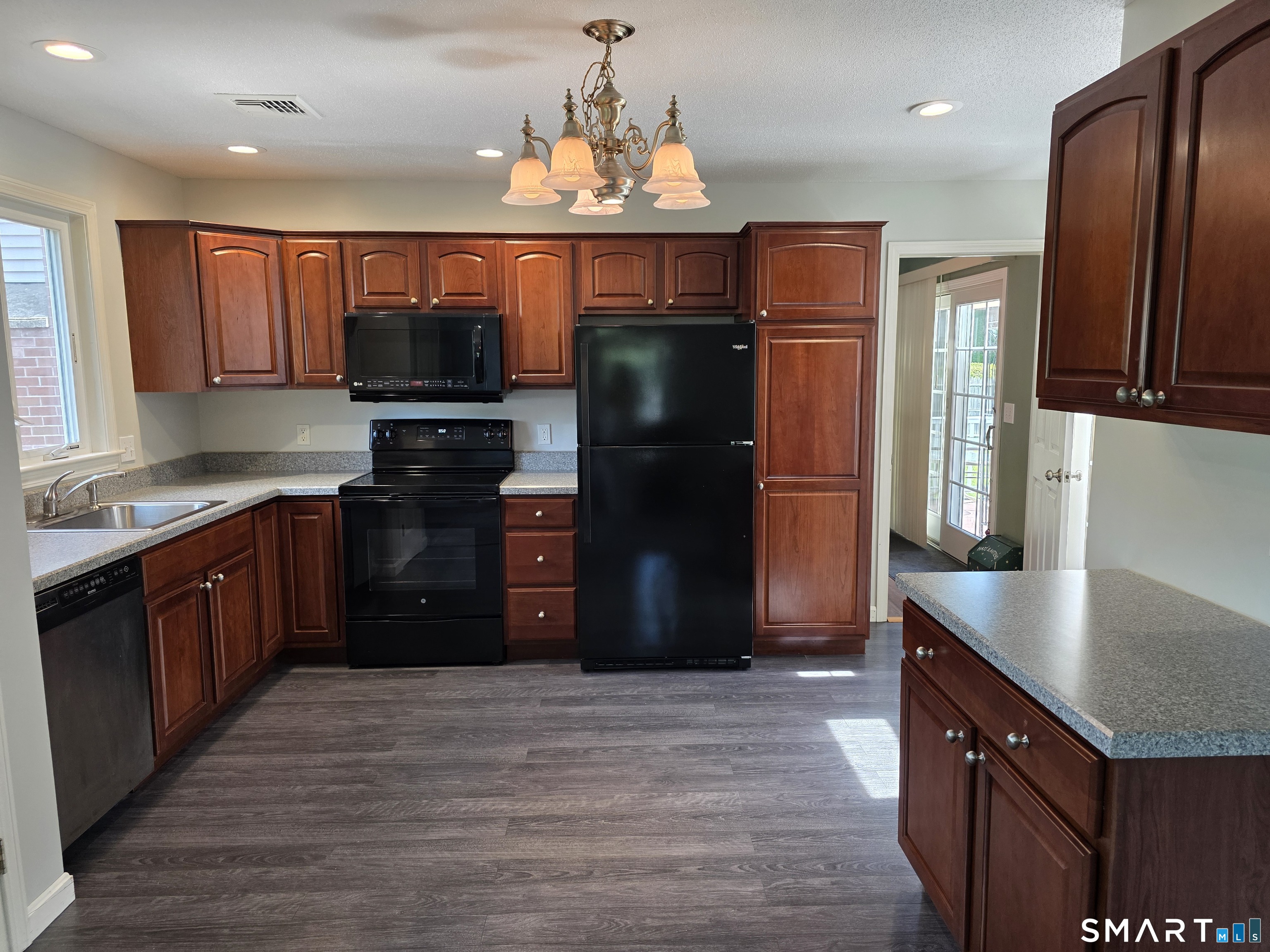 15 Van Buren Road Enfield, CT 06082 - Photo 34 of 40 a kitchen with stainless steel appliances granite countertop a refrigerator and a sink