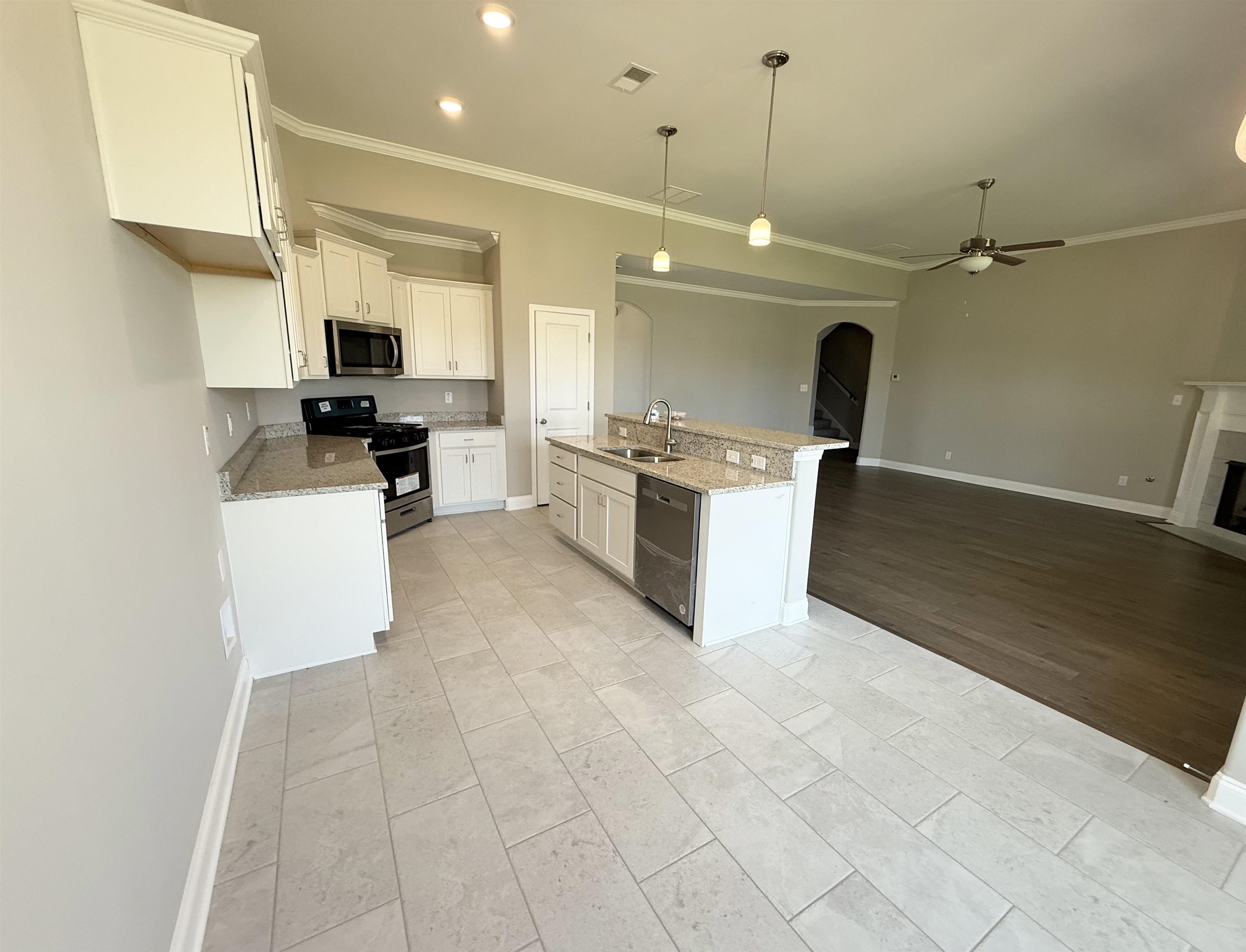 115 Misty Rdg Loop Oakland, TN 38060 - Photo 29 of 29 Kitchen with arched walkways, ceiling fan, appliances with stainless steel finishes, crown molding, and open floor plan