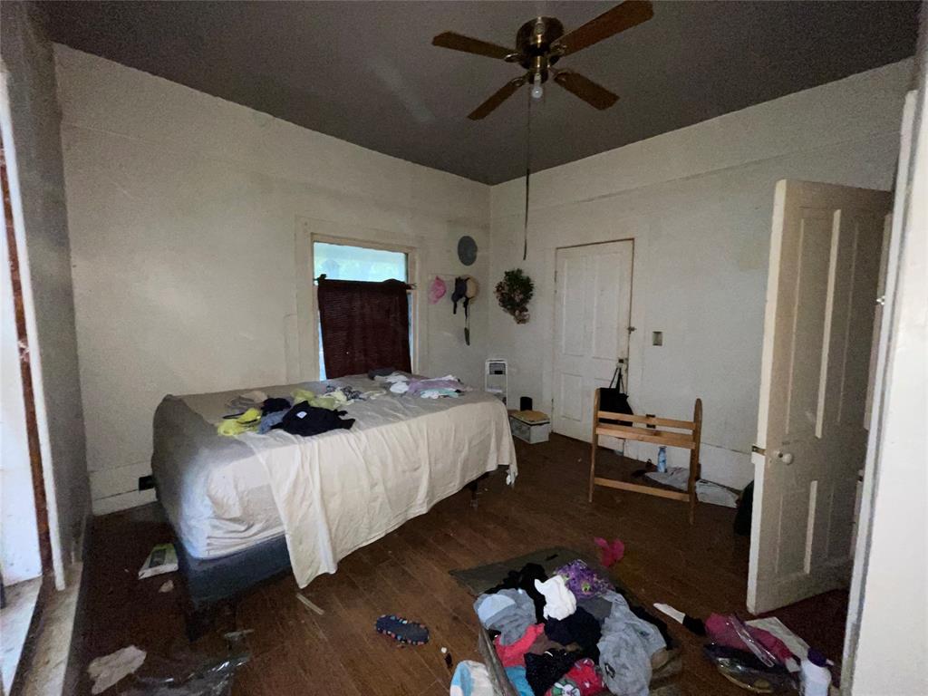 408 North Wichita Street Electra, TX 76360 - Photo 7 of 23 a bedroom with a bed and wooden floor