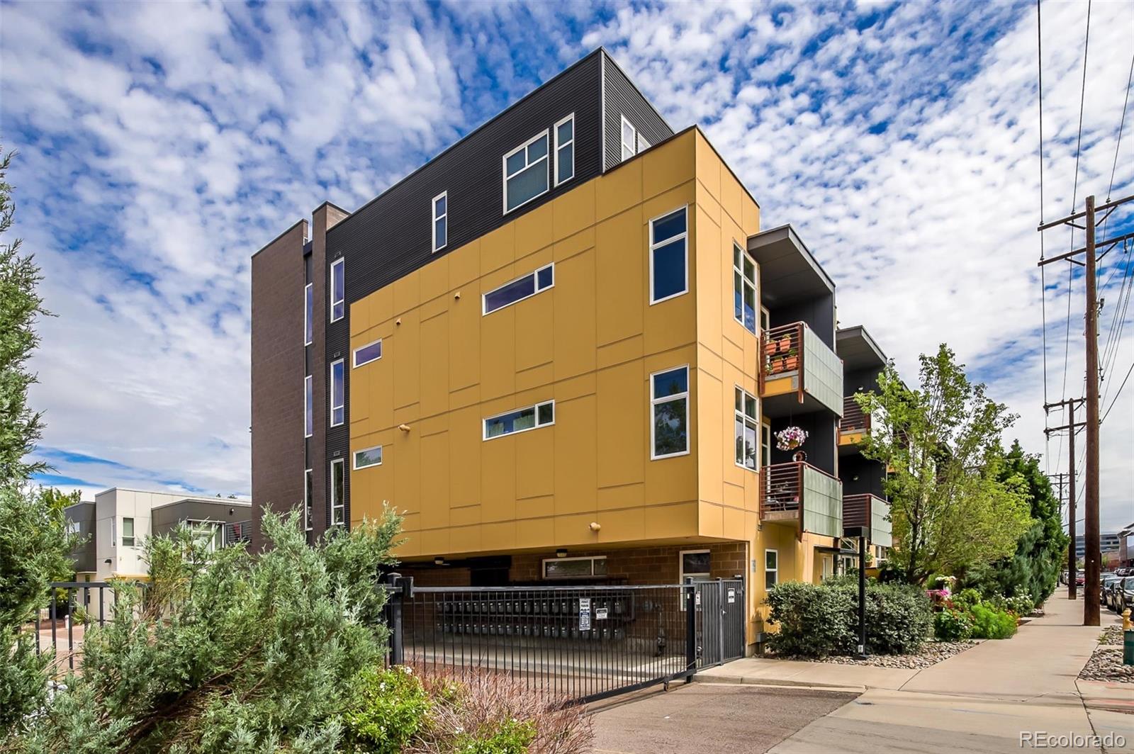 3101 Blake Street, Unit 305 Denver, CO 80205 - Photo 1 of 28 a front view of a house with a yard
