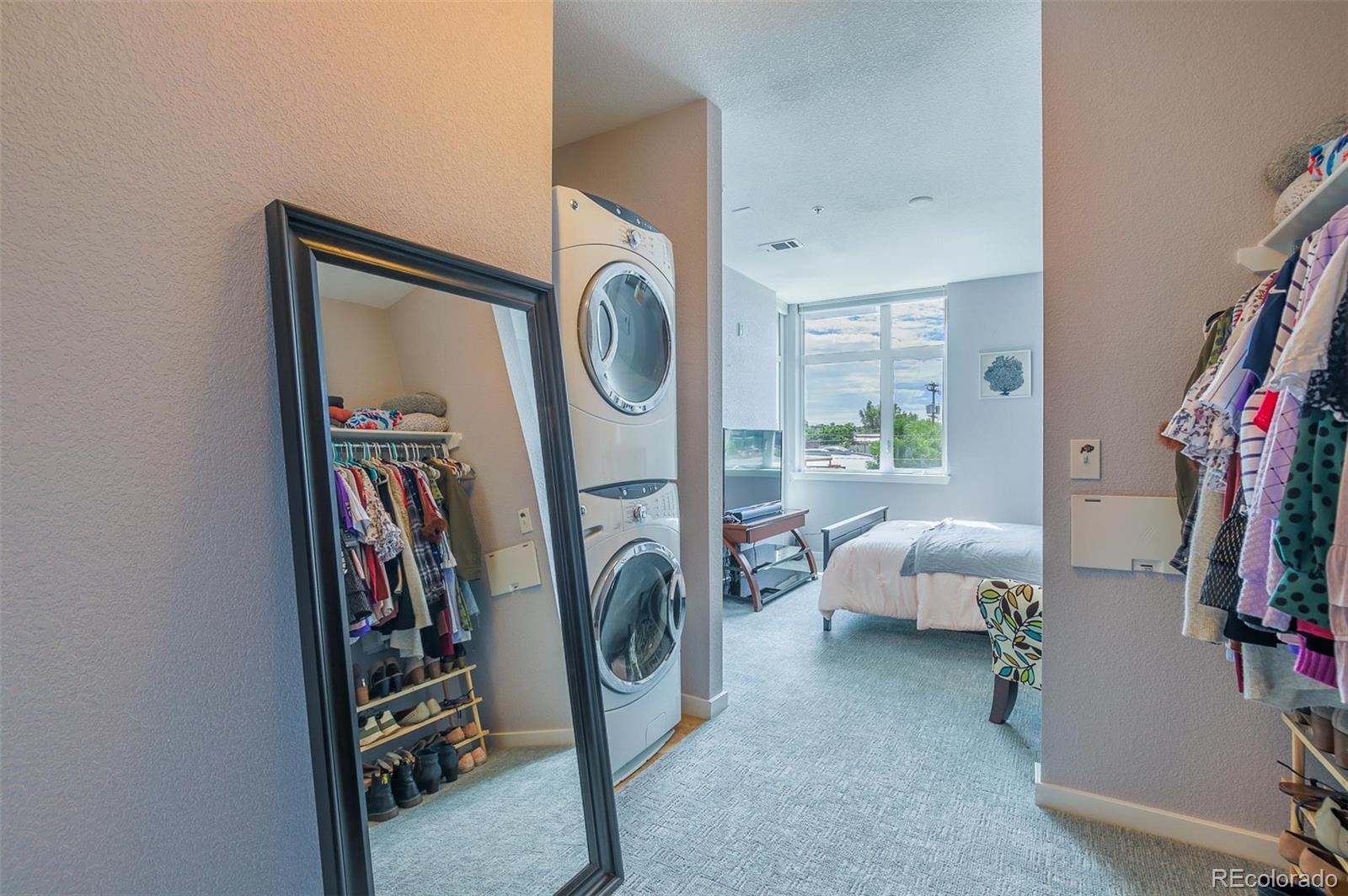 3101 Blake Street, Unit 305 Denver, CO 80205 - Photo 14 of 28 a view of a bedroom with washer and dryer