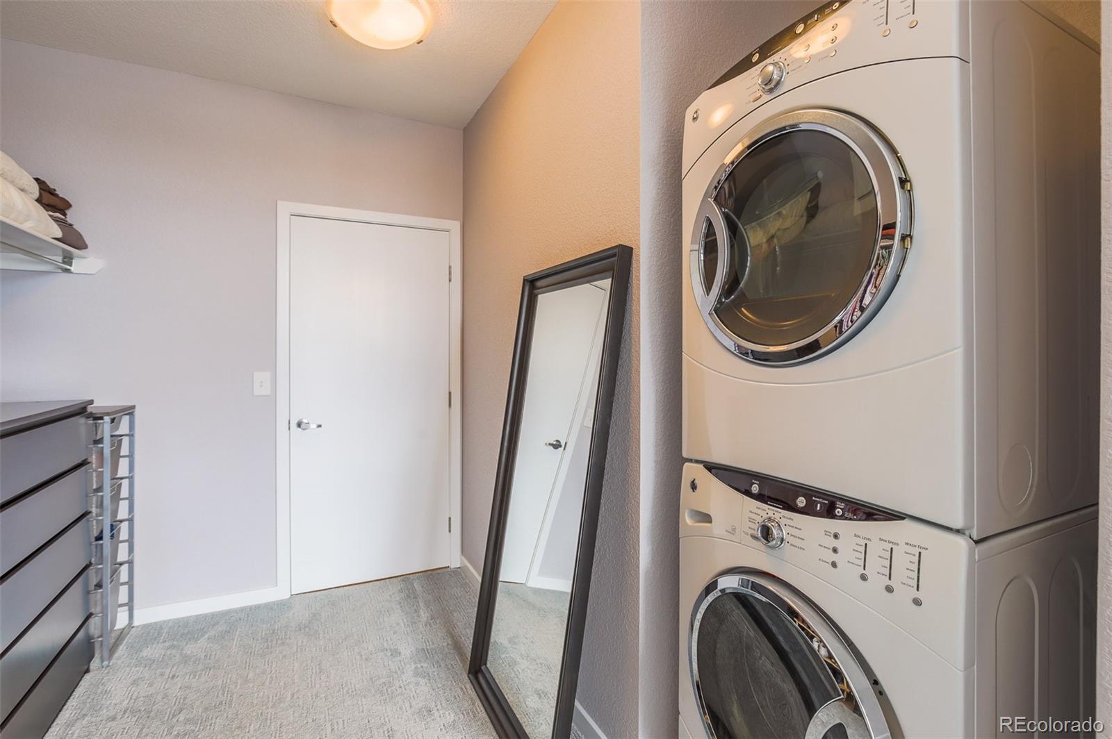 3101 Blake Street, Unit 305 Denver, CO 80205 - Photo 15 of 28 a view of a hallway with washer and dryer