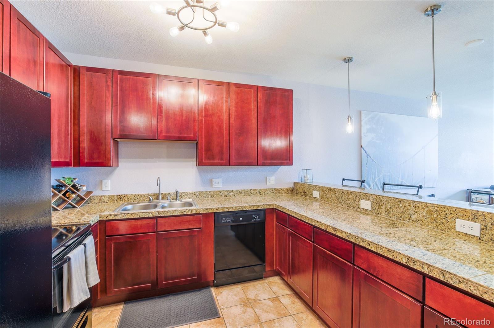 3101 Blake Street, Unit 305 Denver, CO 80205 - Photo 19 of 28 a kitchen with a sink stove and cabinets