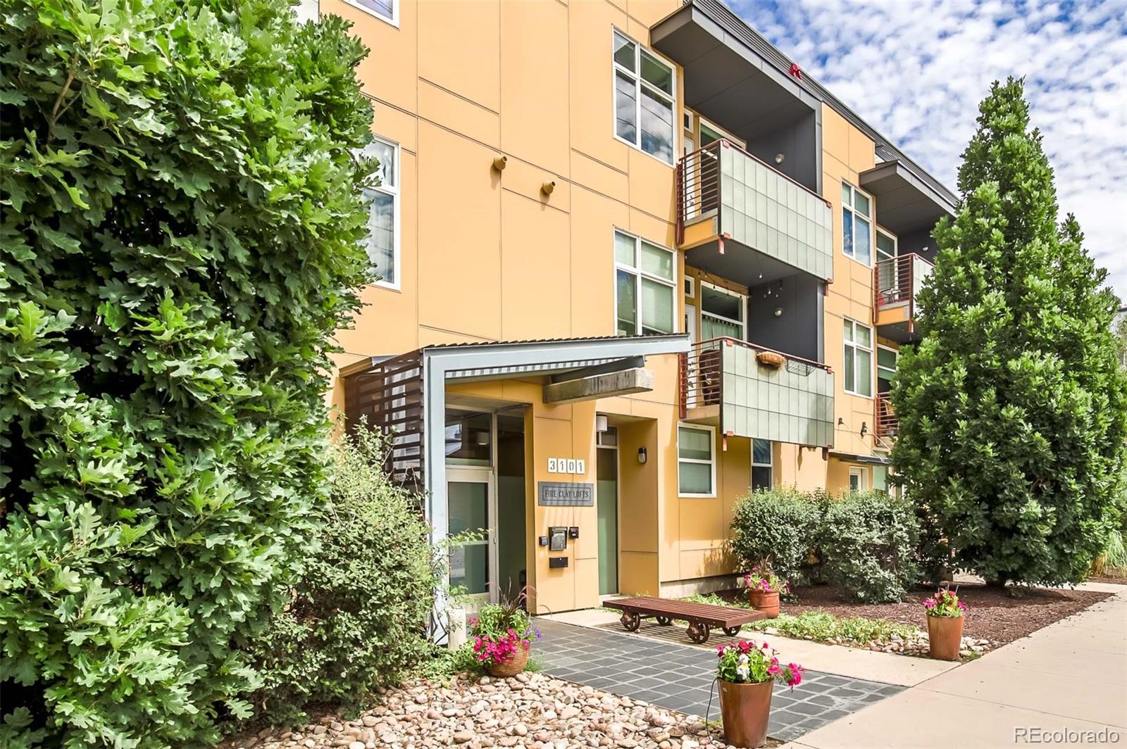 3101 Blake Street, Unit 305 Denver, CO 80205 - Photo 25 of 28 a front view of a house with a yard
