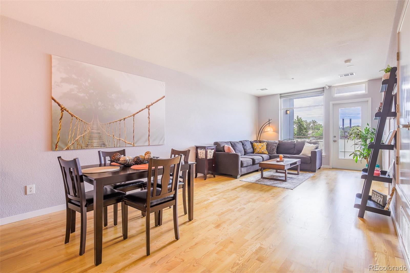3101 Blake Street, Unit 305 Denver, CO 80205 - Photo 4 of 28 a view of a livingroom with furniture and wooden floor