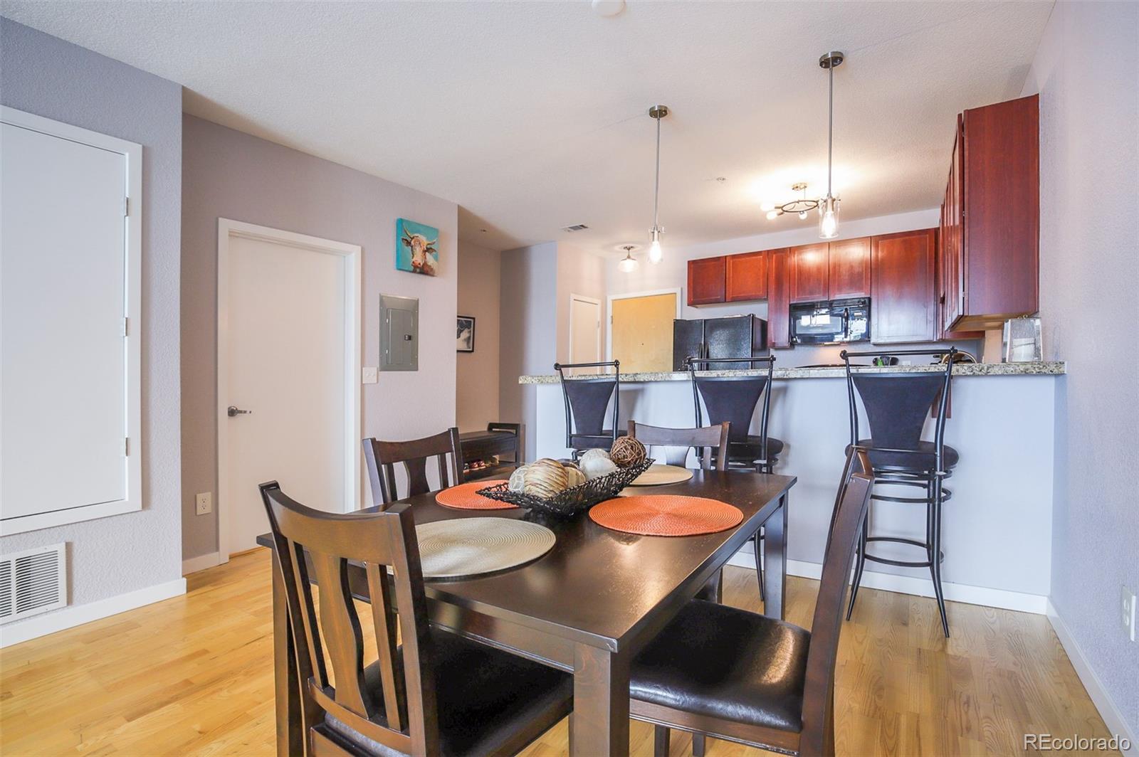 3101 Blake Street, Unit 305 Denver, CO 80205 - Photo 5 of 28 a dining room with furniture and wooden floor