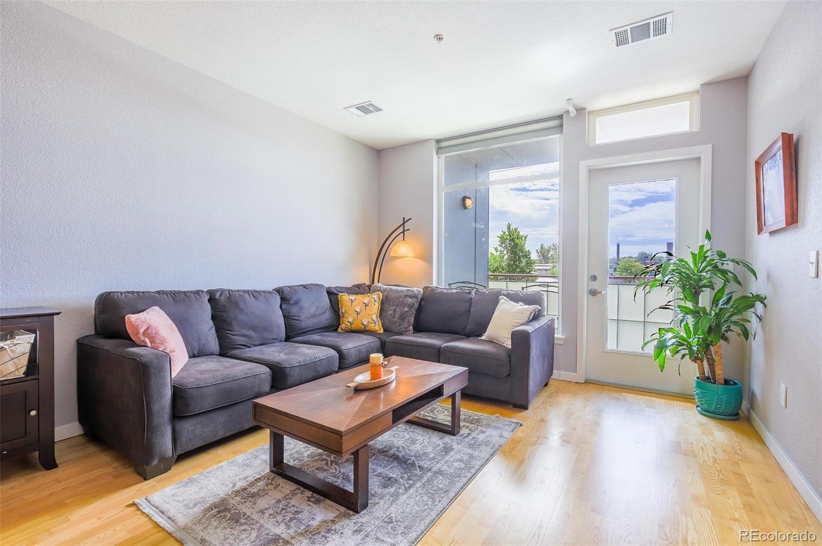 3101 Blake Street, Unit 305 Denver, CO 80205 - Photo 6 of 28 a living room with furniture lamp and a potted plant