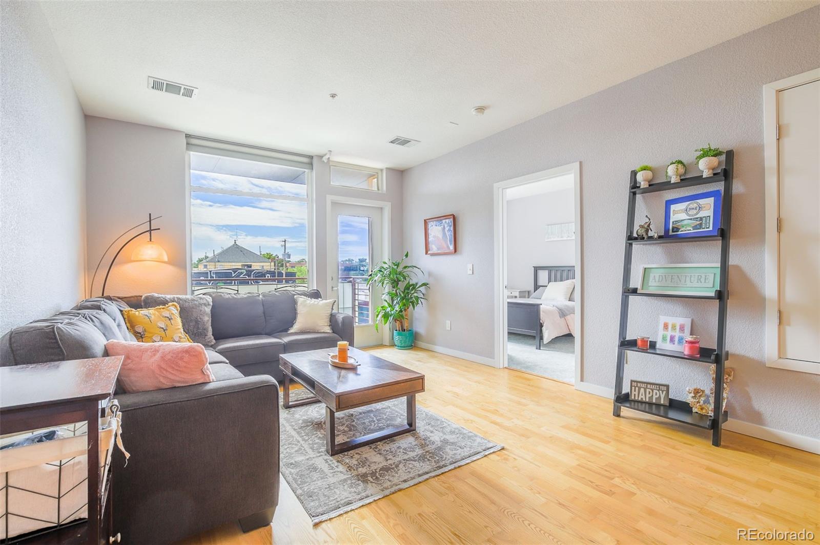 3101 Blake Street, Unit 305 Denver, CO 80205 - Photo 9 of 28 a living room with furniture and a wooden floor