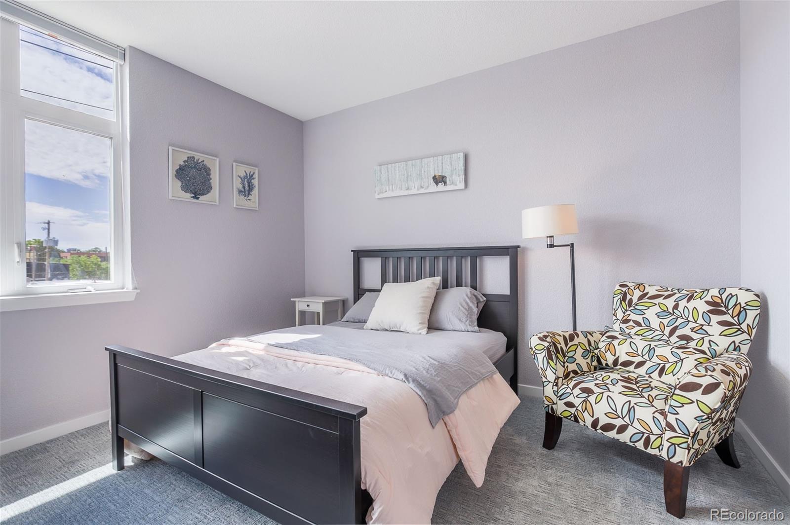 3101 Blake Street, Unit 305 Denver, CO 80205 - Photo 10 of 28 a bedroom with a bed and a window