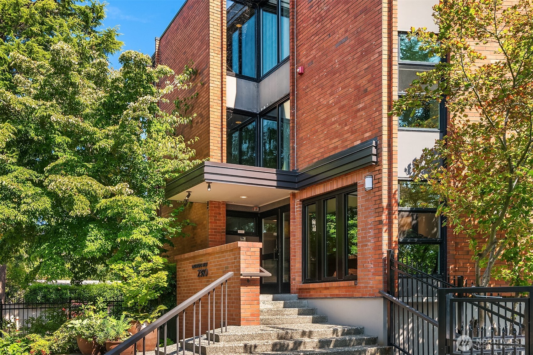 2360 43rd Avenue East, Unit 211 Seattle, WA 98112 - Photo 1 of 26 front view of a house with a tree