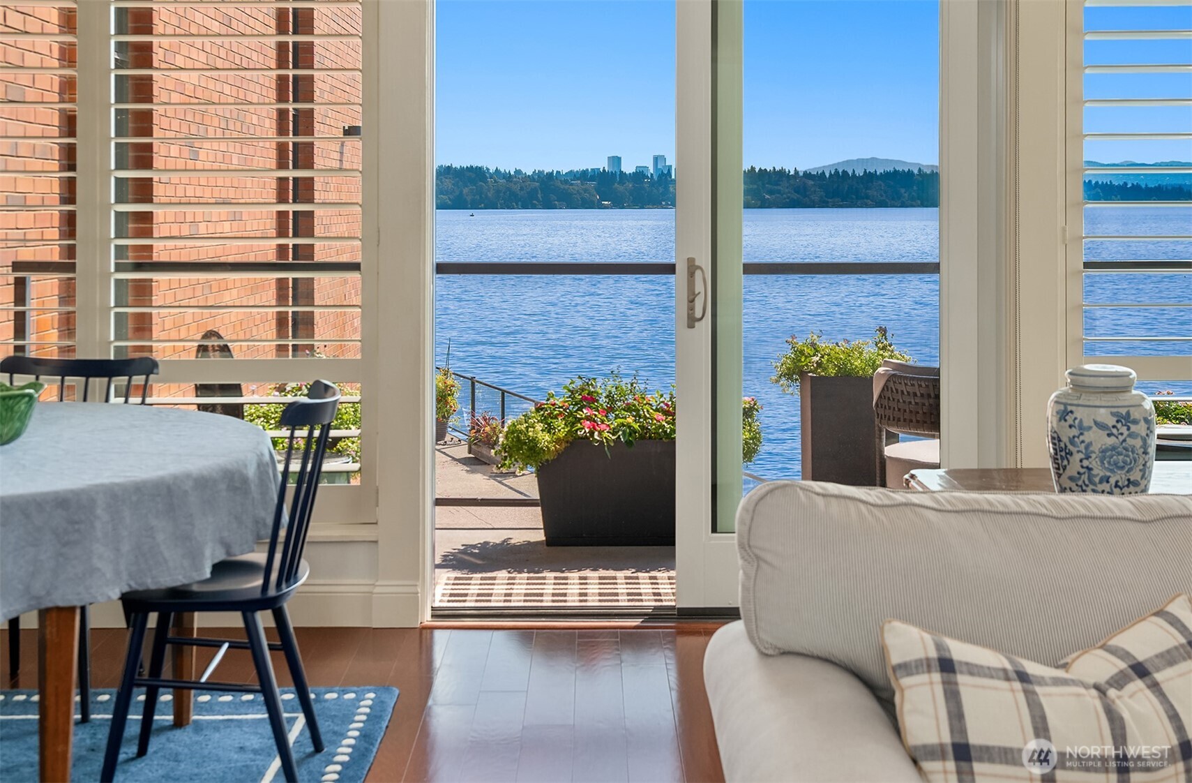 2360 43rd Avenue East, Unit 211 Seattle, WA 98112 - Photo 11 of 26 a view of a dining room with furniture and wooden floor
