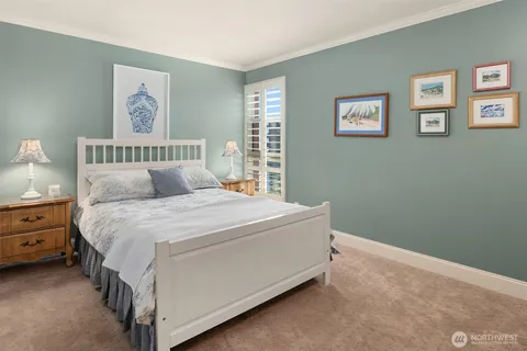 a bed sitting in a bedroom next to a window