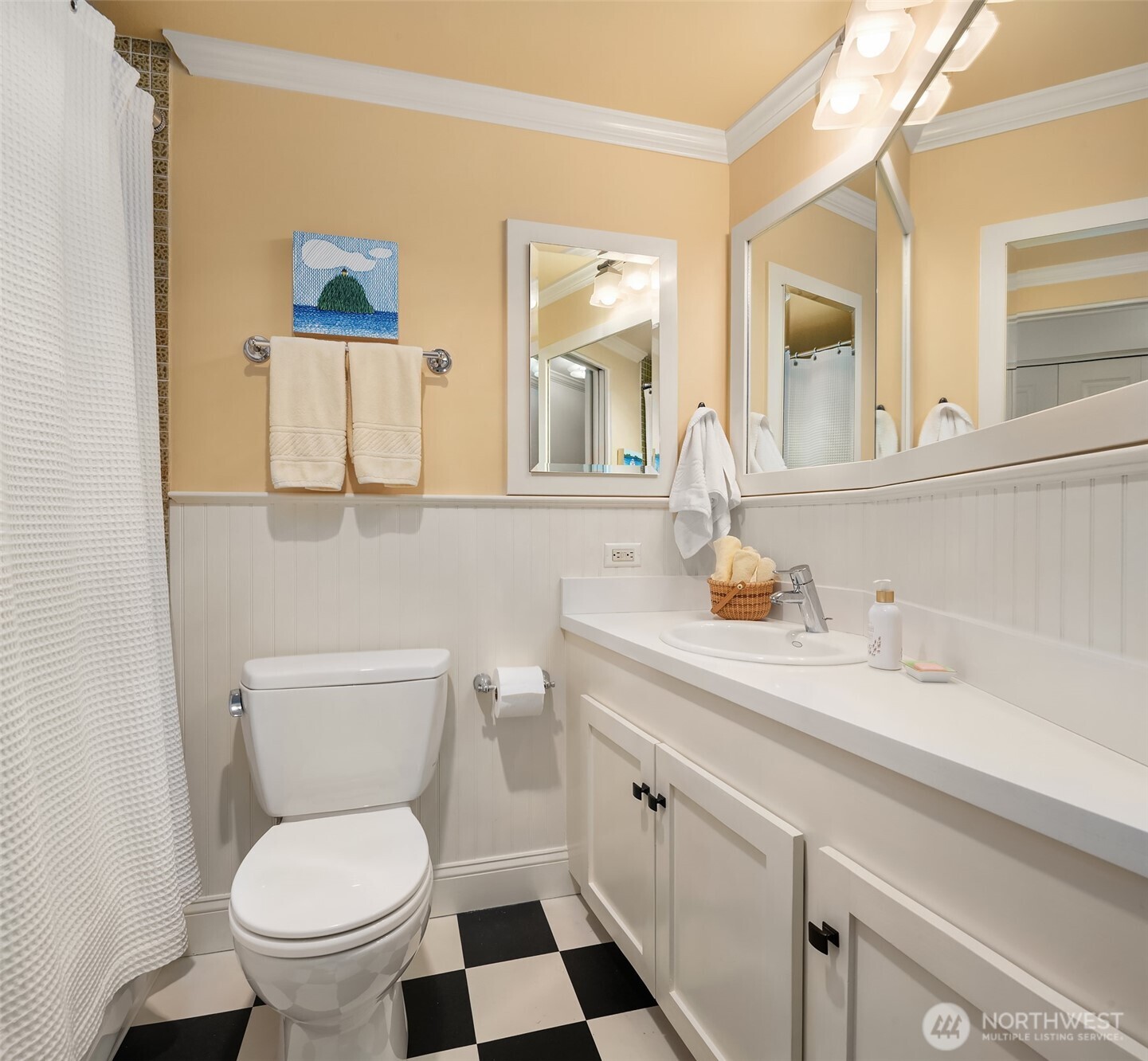 2360 43rd Avenue East, Unit 211 Seattle, WA 98112 - Photo 17 of 26 a bathroom with a toilet a sink and mirror