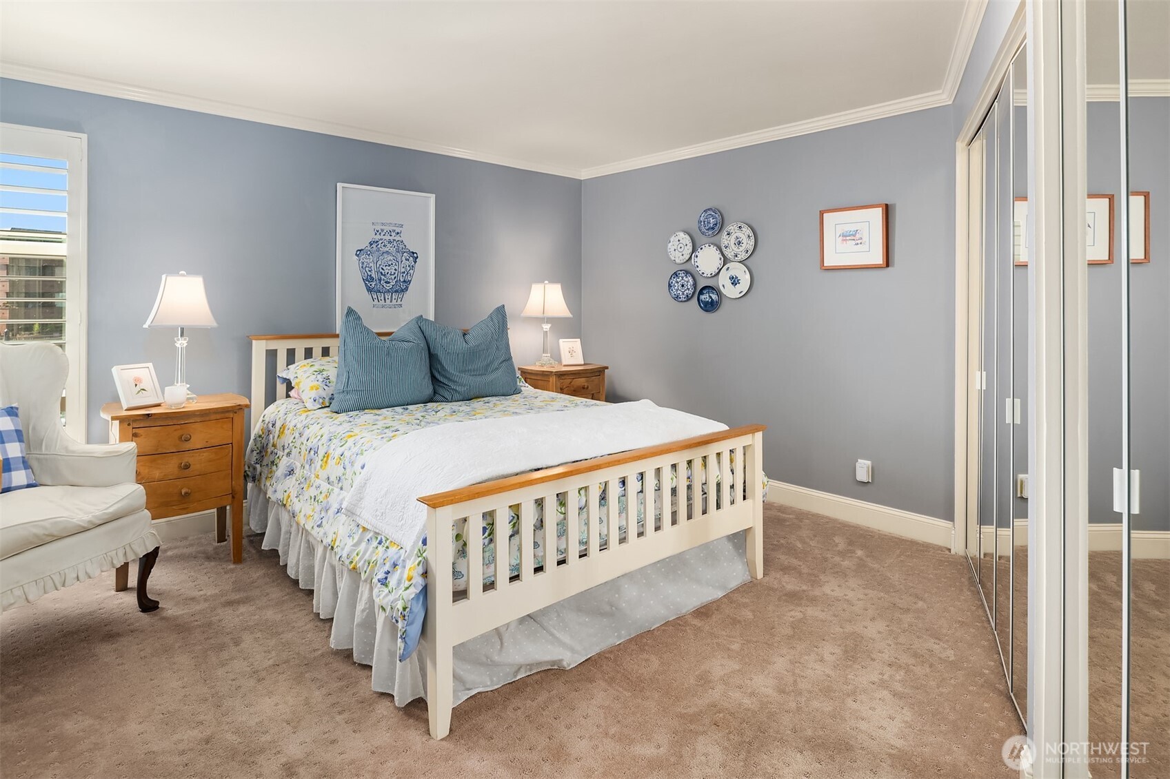 2360 43rd Avenue East, Unit 211 Seattle, WA 98112 - Photo 18 of 26 a bed sitting in a bedroom next to a lamp