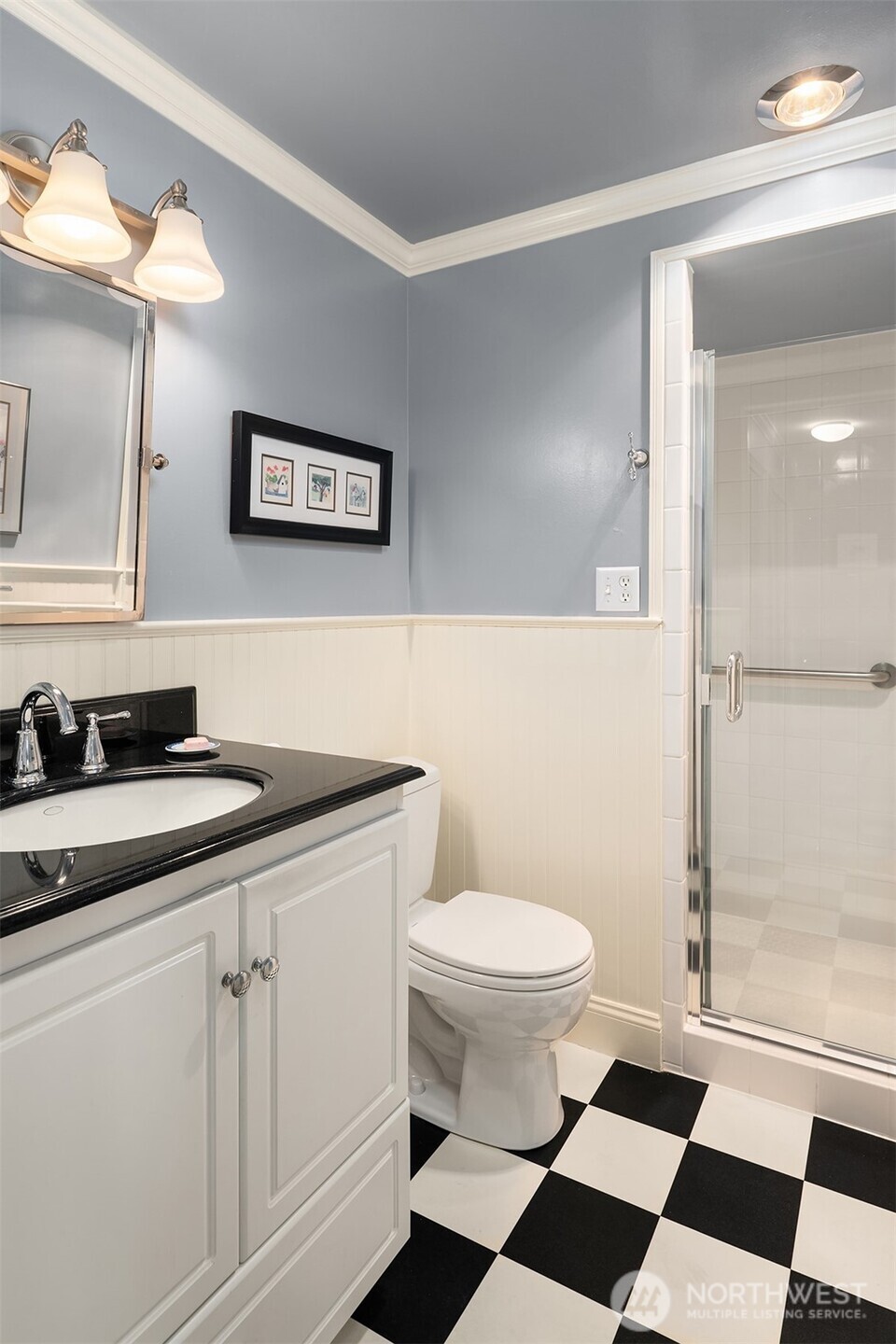 2360 43rd Avenue East, Unit 211 Seattle, WA 98112 - Photo 20 of 26 a bathroom with a sink a toilet a mirror and shower
