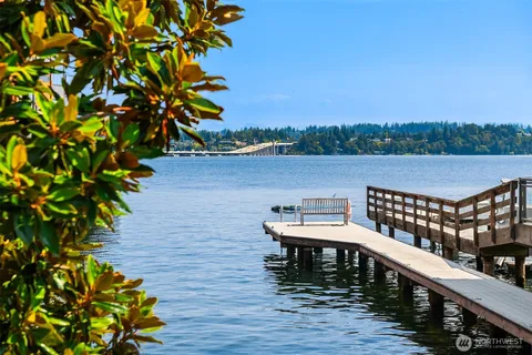 a balcony with wooden floor and lake view