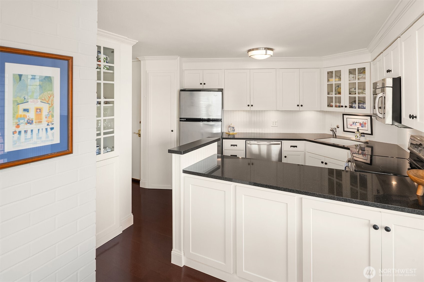 2360 43rd Avenue East, Unit 211 Seattle, WA 98112 - Photo 7 of 26 a kitchen with a sink and a refrigerator