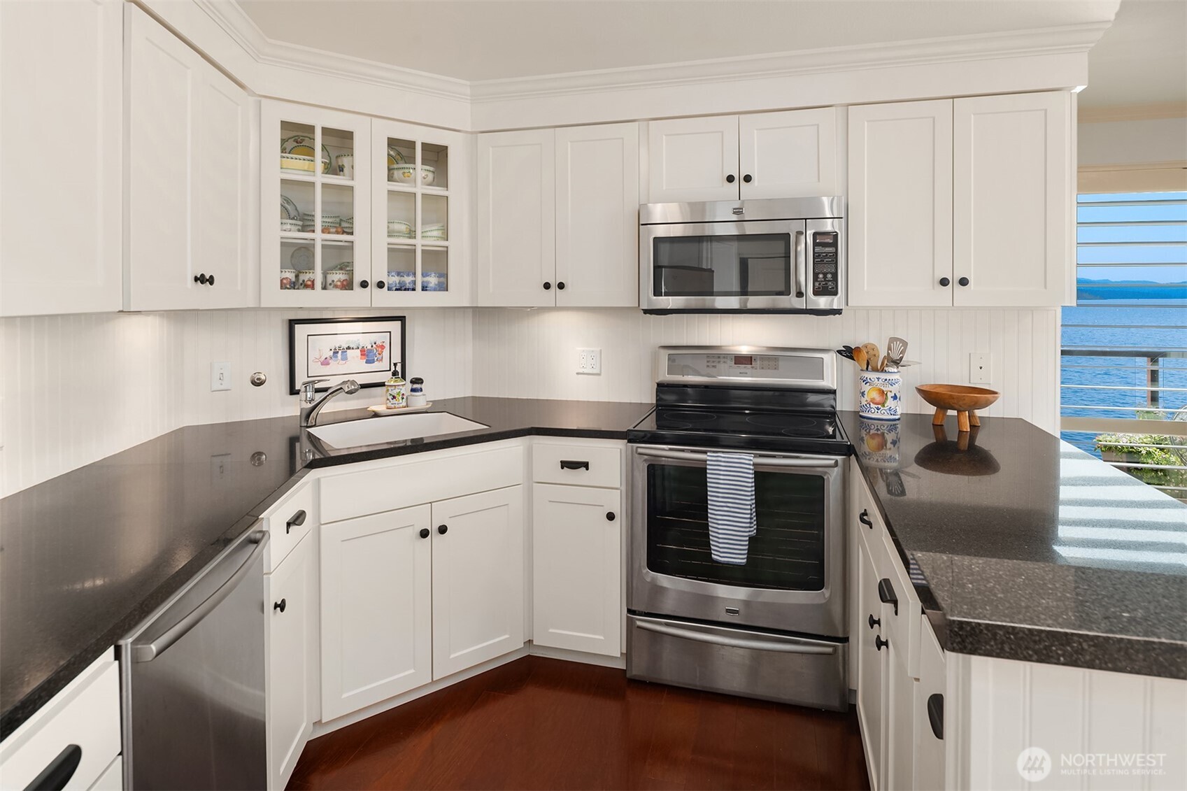 2360 43rd Avenue East, Unit 211 Seattle, WA 98112 - Photo 8 of 26 a kitchen with granite countertop white cabinets and appliances