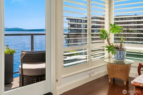 a window with a potted plant on a table