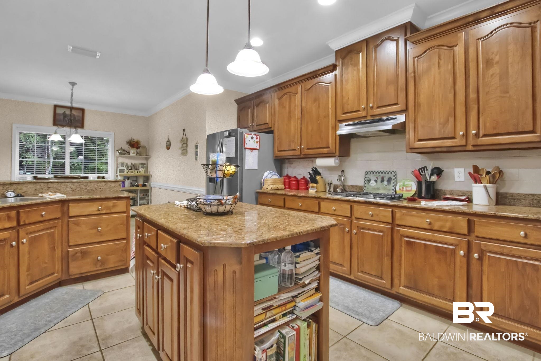 1 Bens Bluff Daphne, AL 36527 - Photo 19 of 56 Kitchen with a kitchen island, pendant lighting, stainless steel appliances, ornamental molding, and a chandelier