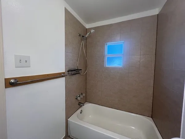 a bathroom with a bathtub and a shower