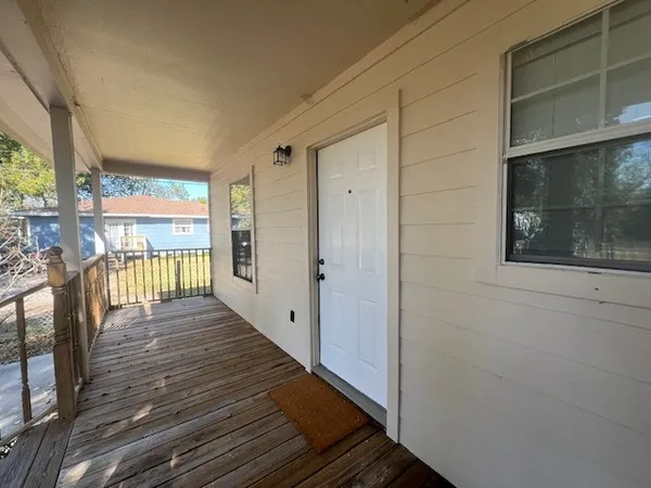 a view of a balcony with wooden floor