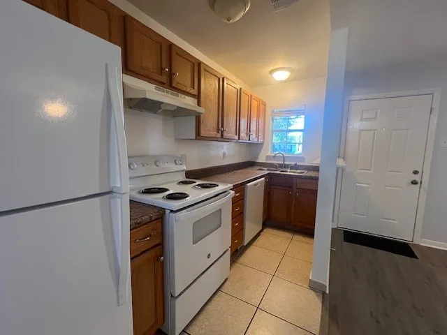 an empty room with wooden floor and closet