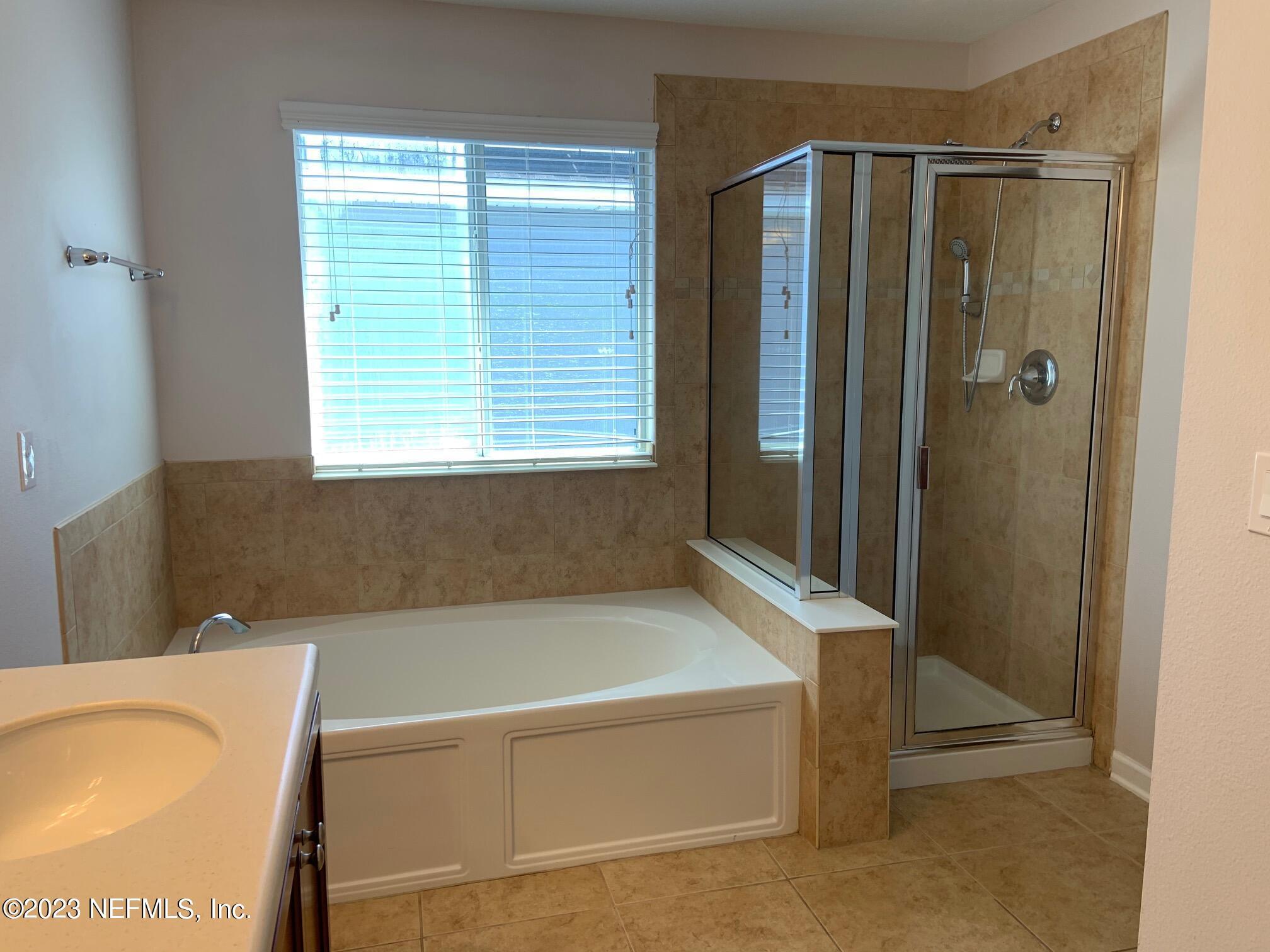 3863 Chasing Falls Road Orange Park, FL 32065 - Photo 23 of 32 a bathroom with a bathtub and a shower