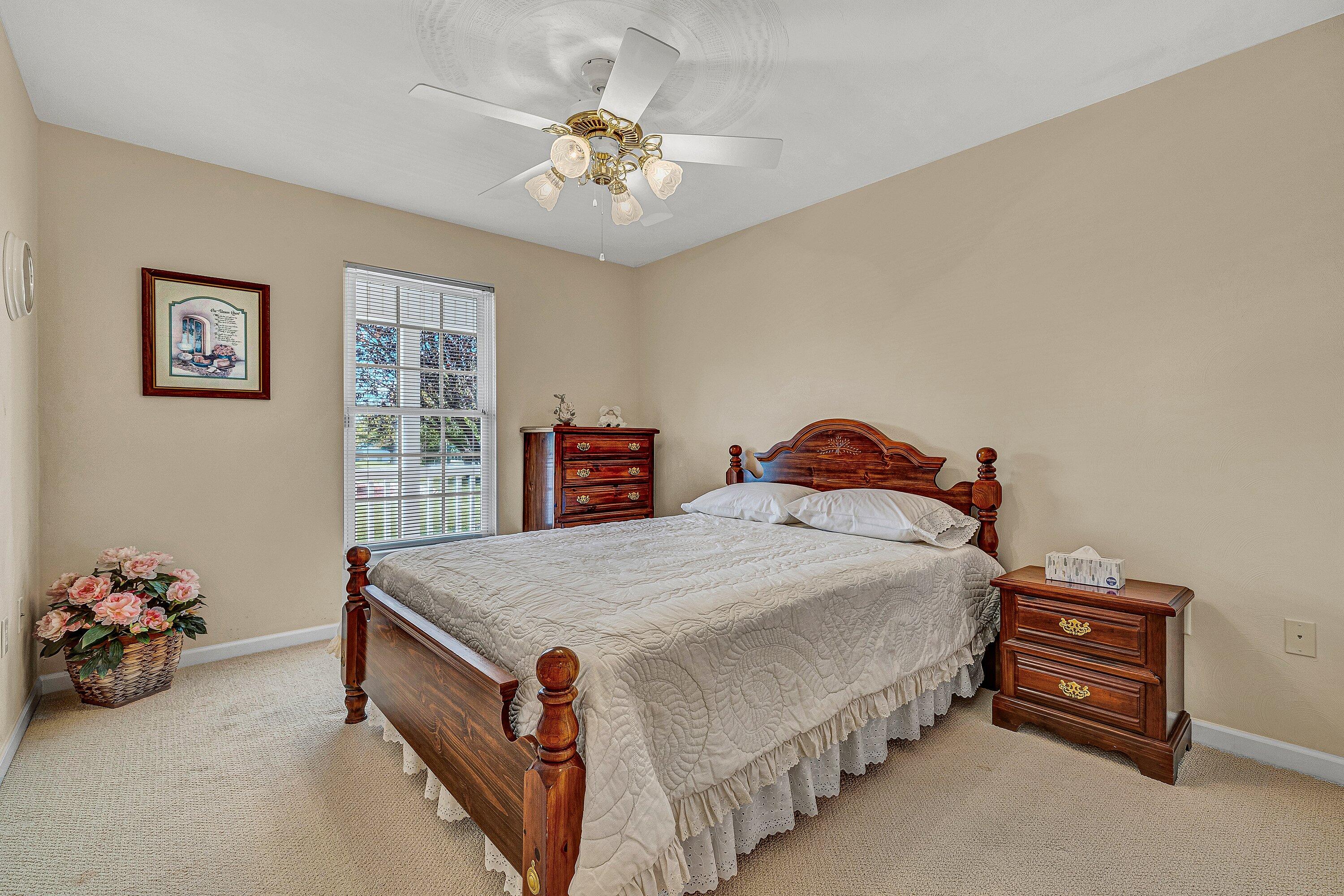1850 Emmaus Church Road Moneta, VA 24121 - Photo 23 of 63 a spacious bedroom with a bed and a chandelier
