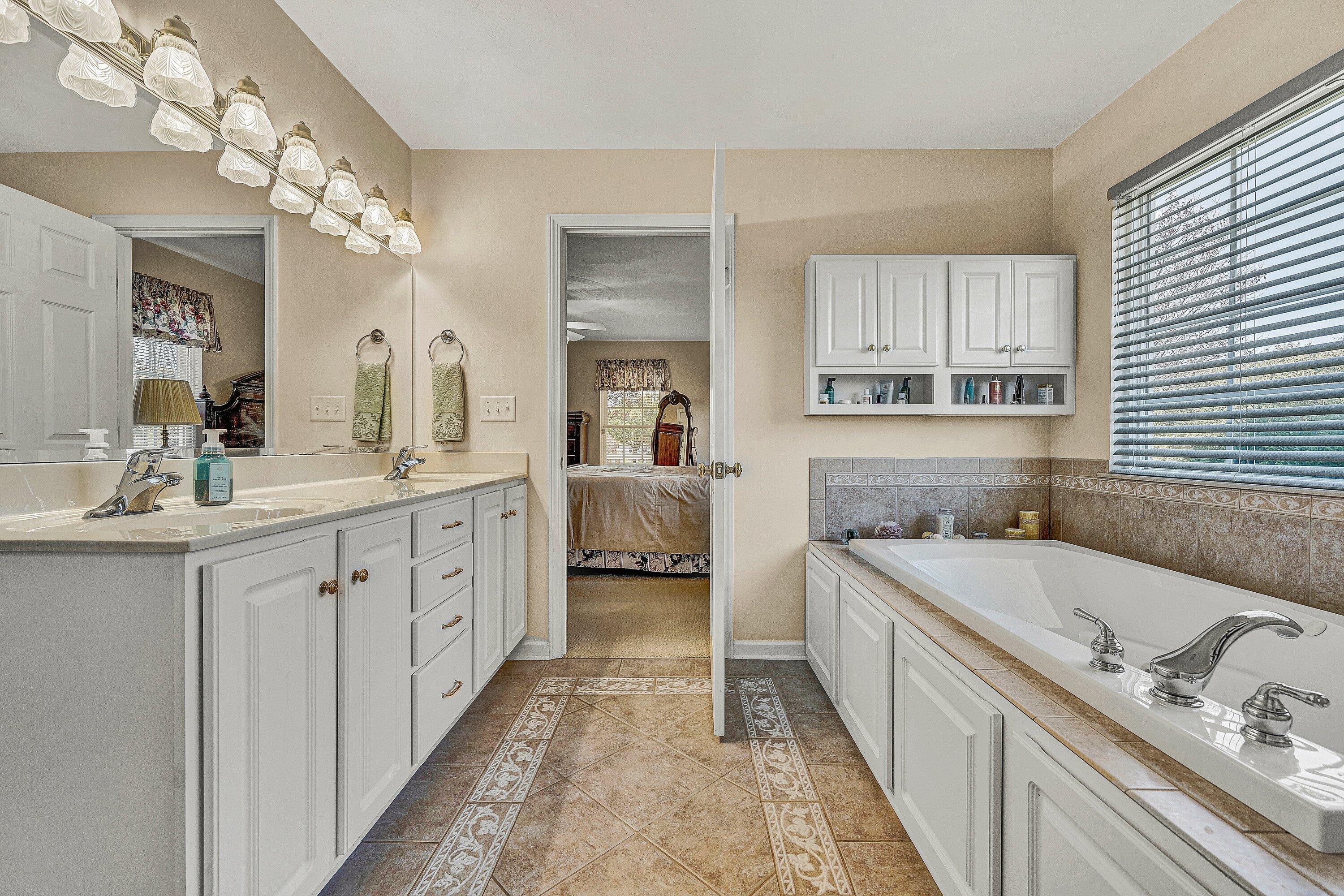 1850 Emmaus Church Road Moneta, VA 24121 - Photo 30 of 63 a spacious en suite bathroom with double sink and a large mirror