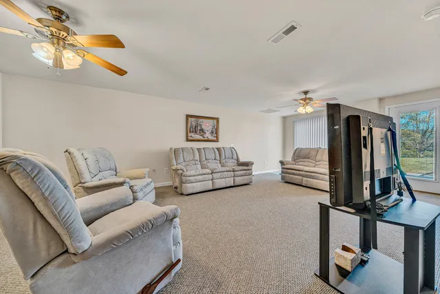 a view of a house with a patio and a yard