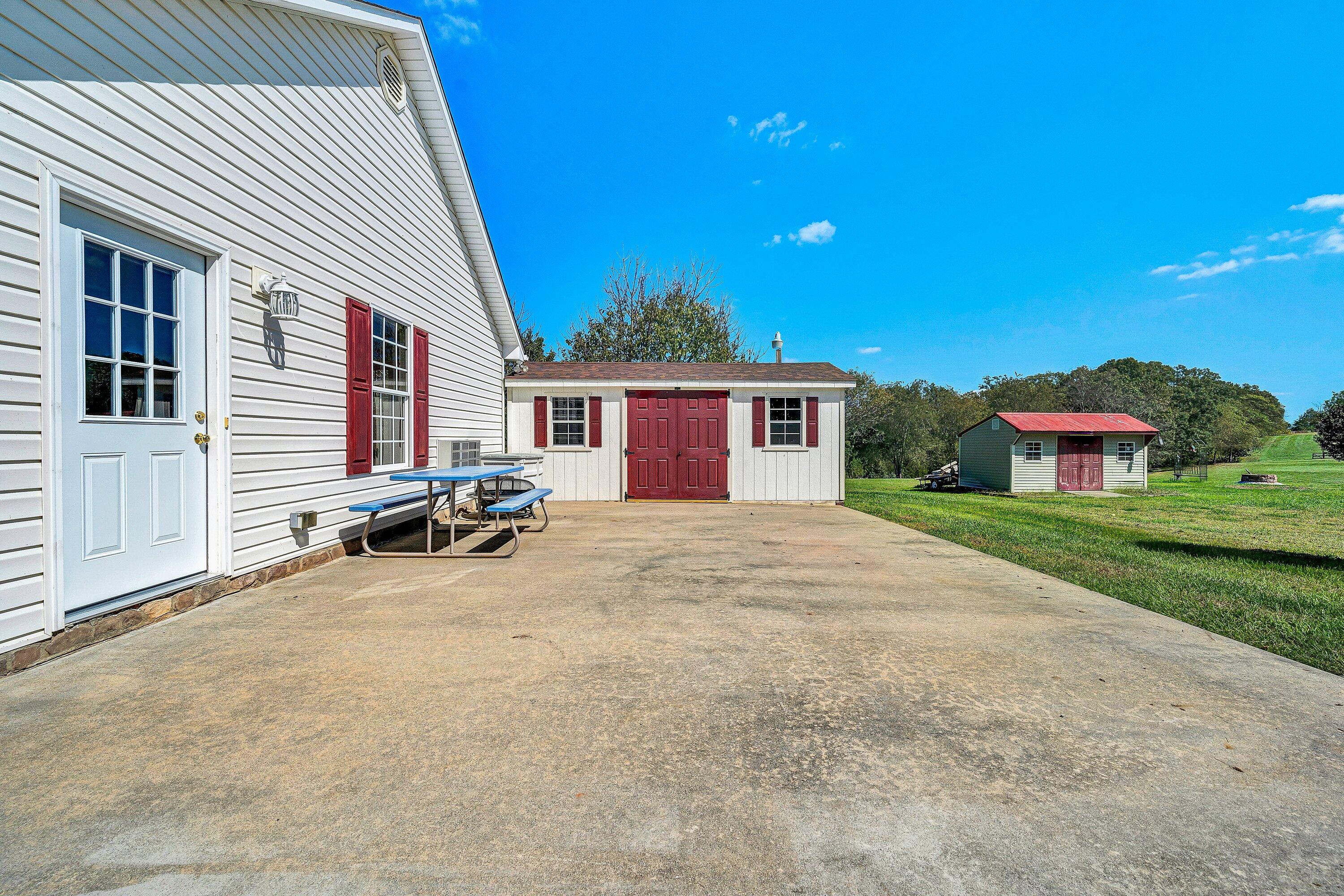 1850 Emmaus Church Road Moneta, VA 24121 - Photo 43 of 63 a view of a house with a patio and a yard